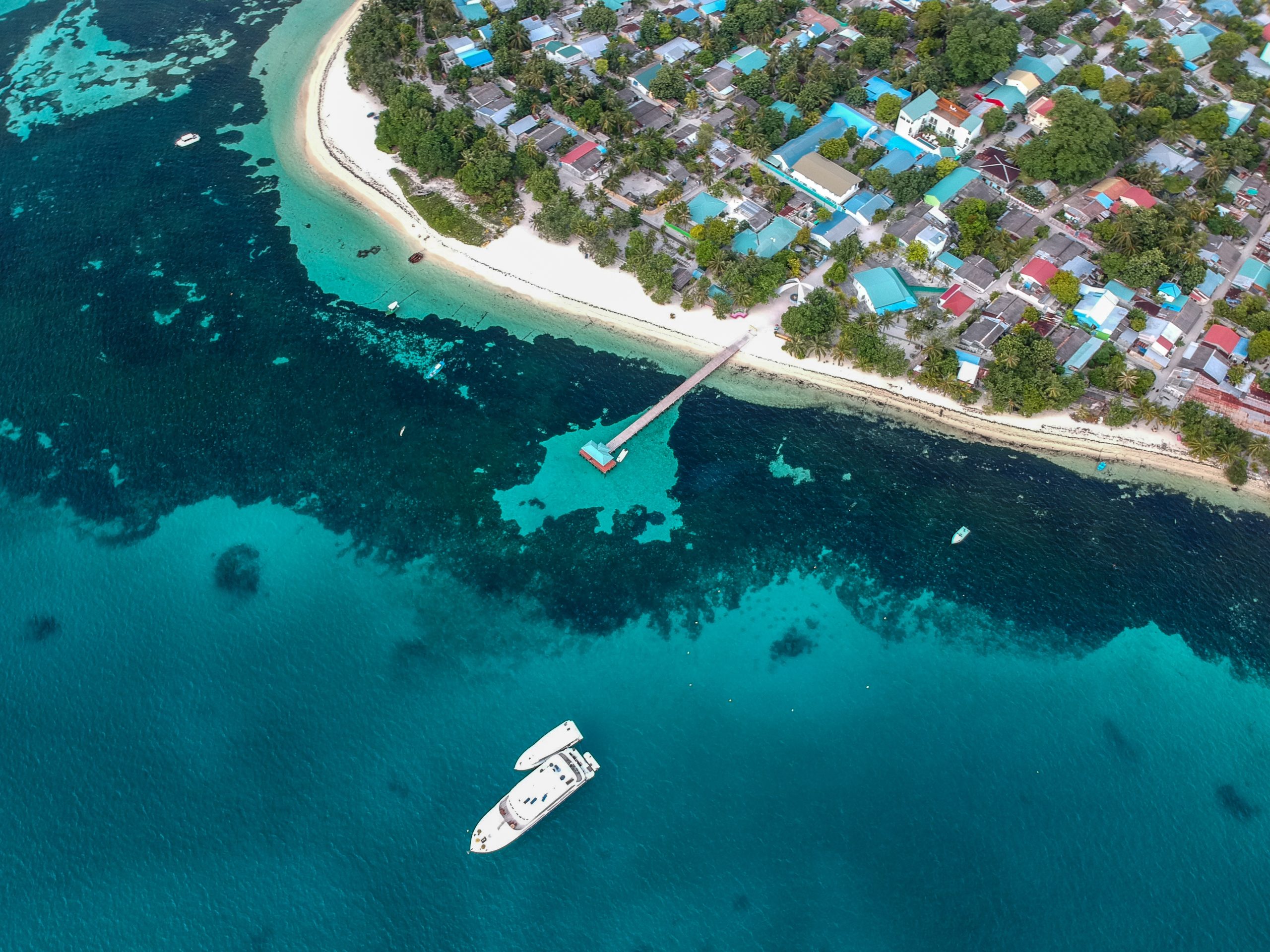 Aerial photography of a ship leaving its port with the [urpose of going and finding new adventures